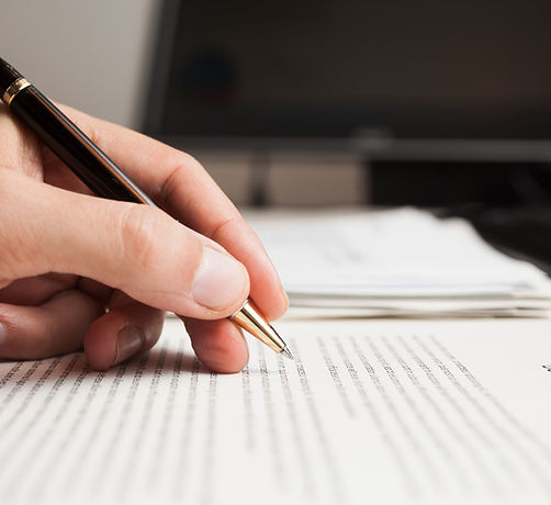 proofreading a document with a pen
