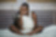young sad and depressed black afro American woman in bed sleepless late night feeling desp