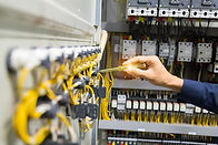 Electrician restoring power in a distribution board
