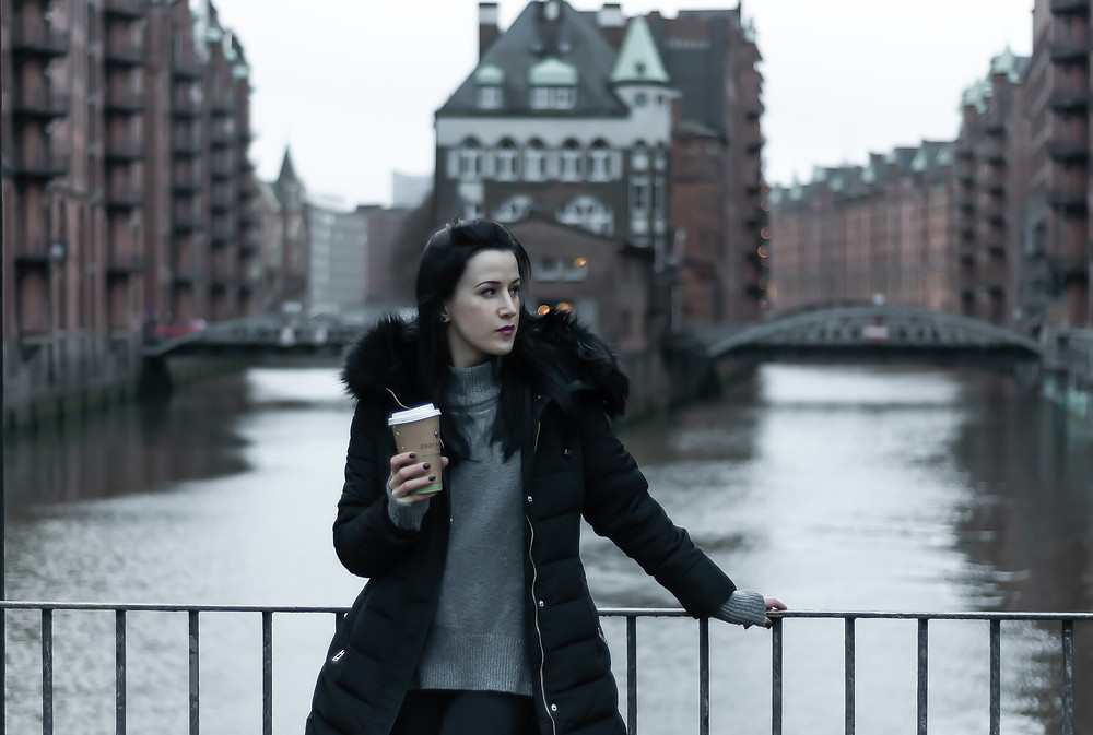 Girl standing in on the bridge in Speicherstadt in Hamburg