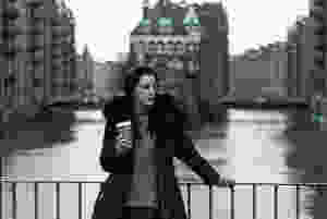 Girl standing in on the bridge in Speicherstadt in Hamburg