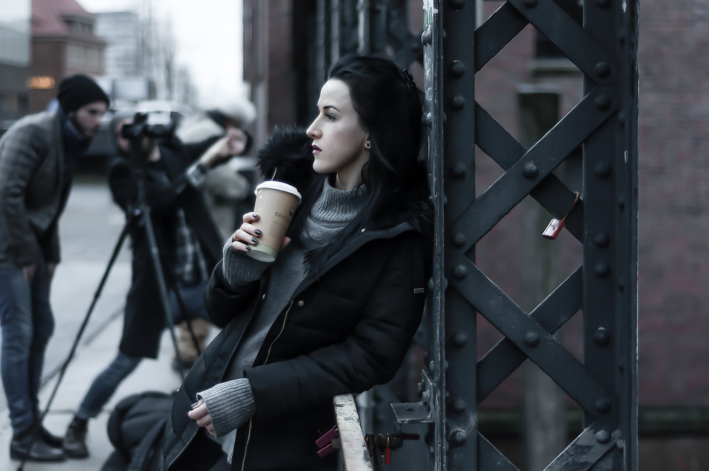 Girl with cup of take away coffee in Hamburg