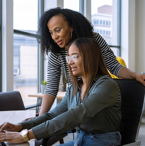 Older woman mentoring young woman.