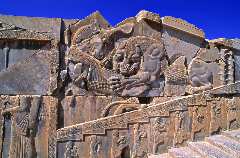 Palazzo di Dario, lotta tra il leone e il capricorno, in primo piano servi con le portate per il banchetto  - Foto di Sergio Pessolano