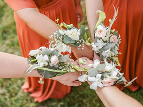 Bracelets fleurs des demoiselles d'honneur le jour du mariage en robe terracotta bohème photographié par Nina Photographie, photographe de mariage lumineux et élégant en Meuse proche de Verdun