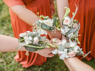 Bracelets fleurs des demoiselles d'honneur le jour du mariage en robe terracotta bohème photographié par Nina Photographie, photographe de mariage lumineux et élégant en Meuse proche de Verdun