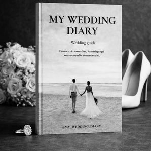 Livre blanc My Wedding Diary sur table, avec bouquet, alliance et escarpins, ambiance élégante.