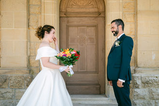 couple de mariés qui se découvre en tenue de mariés le jour de leur mariage. Ils sont émus