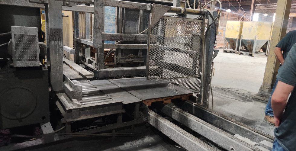 Part of "The Hog Wallow's" conveyor belt, including rollers and the dusty frame.