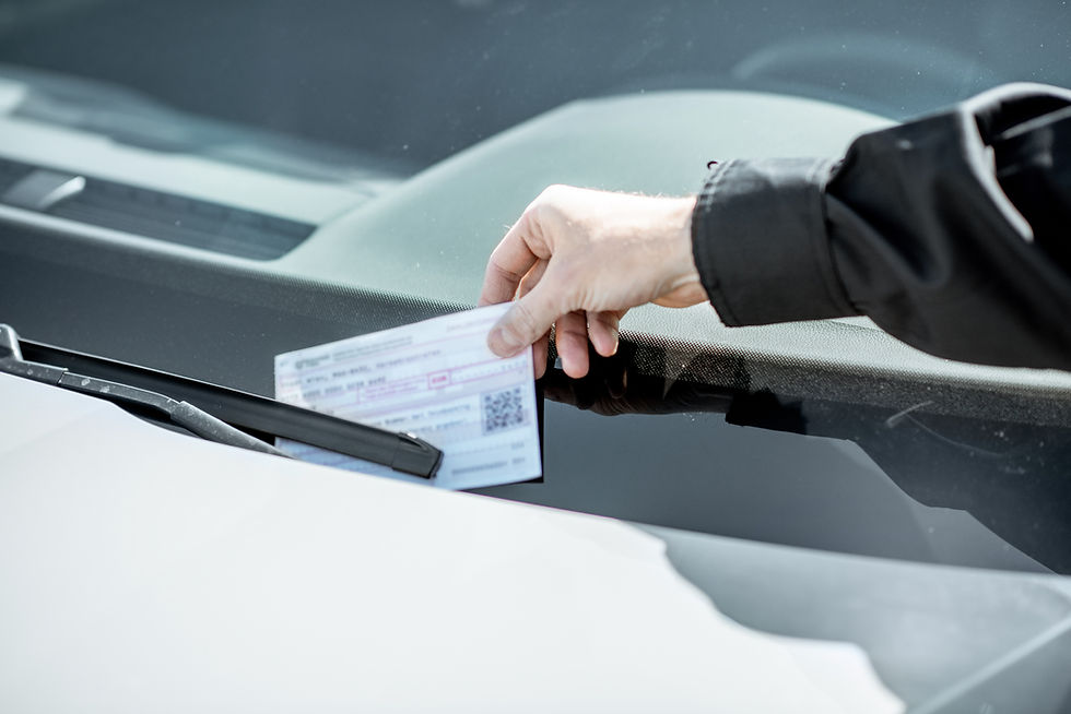 officer putting parking ticket on windshield of car