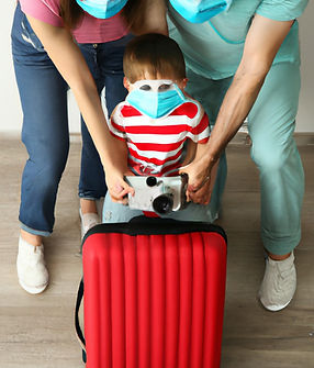 Family photo with suitcase with mask.jpg