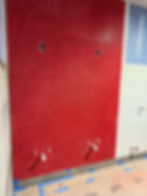 Red penny tiles on wall in shower