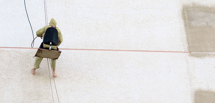 Worker Hanging off Building Sandblasting