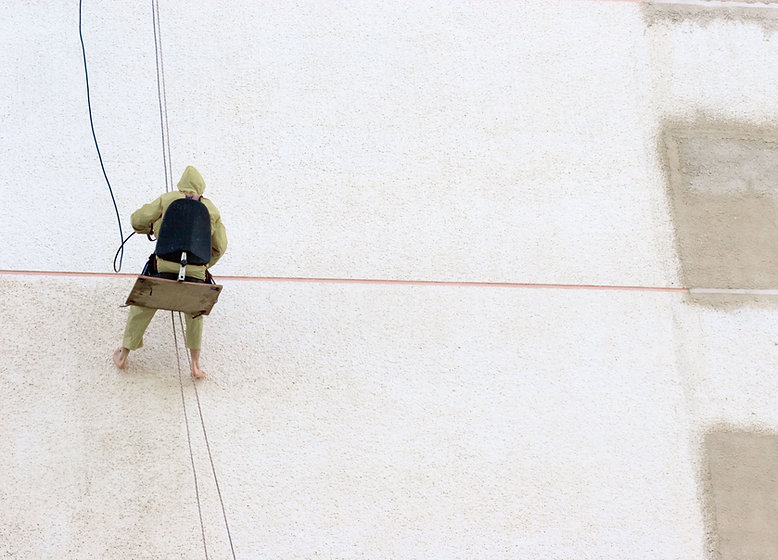 Worker Hanging off Building Sandblasting