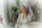 A woman looking at herself in the mirror