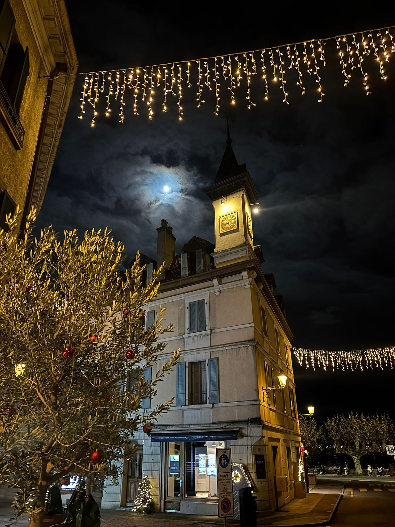 building in nyon at night with moon