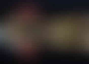 Nyon castle lit up in red from across the lake