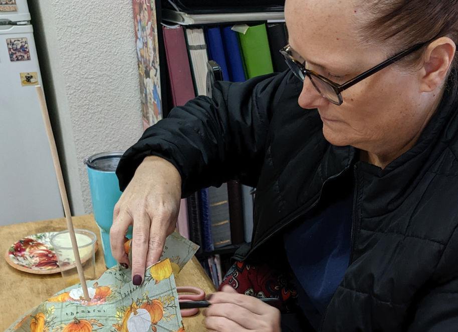 Participant at work decoupaging her pumpkin in Sachse, TX