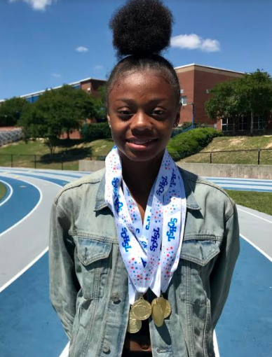 Jayla Jamison poses recently on Airport High’s track with some of the medals she won at this spring’s state championships.