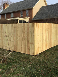 Six-foot wooden privacy fence. Click to visit apluscontractors.us/fencing-services