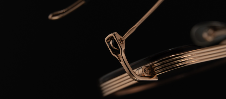 Close-up of the KIO YAMATO KP-284U titanium nose pad in Rose Gold, engraved with the KIO YAMATO emblem. The striped enamel detailing reflects light with precision, emphasizing the frame’s craftsmanship and material purity.