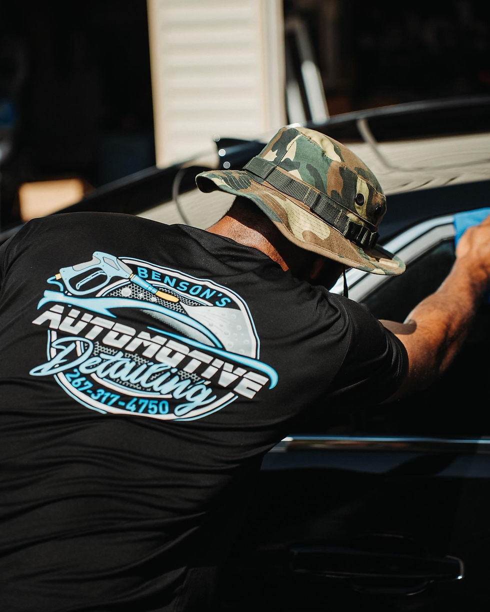 An image of the back of the owner's shirt displaying its company logo for Benson's Auto Detailing.