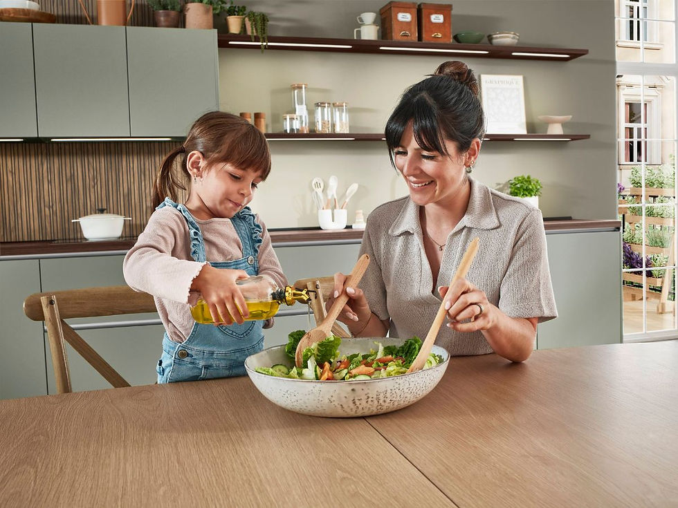 Maman et sa fille qui préparent une salade ensemble dans la cuisine