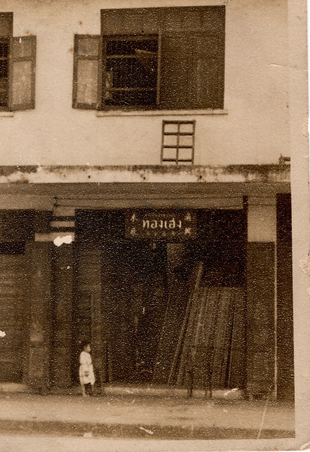 A vintage sepia-toned photograph of the Thong Heng wood shop exterior at Golden Mount, Bangkok, representing the second generation of the Roongsrisoothiwong family's woodworking heritage.