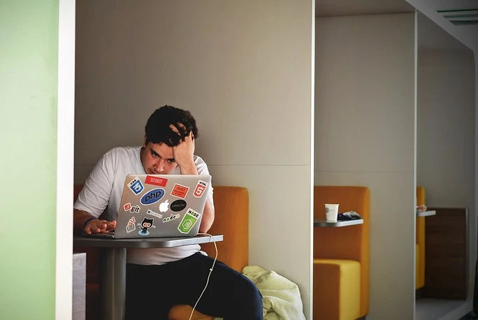 Man Using Laptop but Frustrated with Work