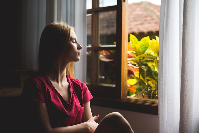 Woman Relaxing Beside Window
