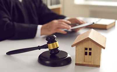 gavel-sits-next-to-small-wooden-house-model-in-front-of-foreclosure-attorney.jpeg