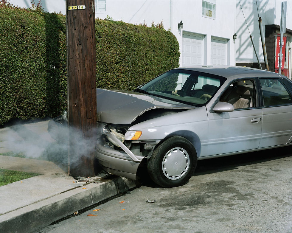 Car crash against telephone pole by road.jpg
