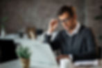 mid-adult-businessman-using-computer-while-working-office (1).jpg
