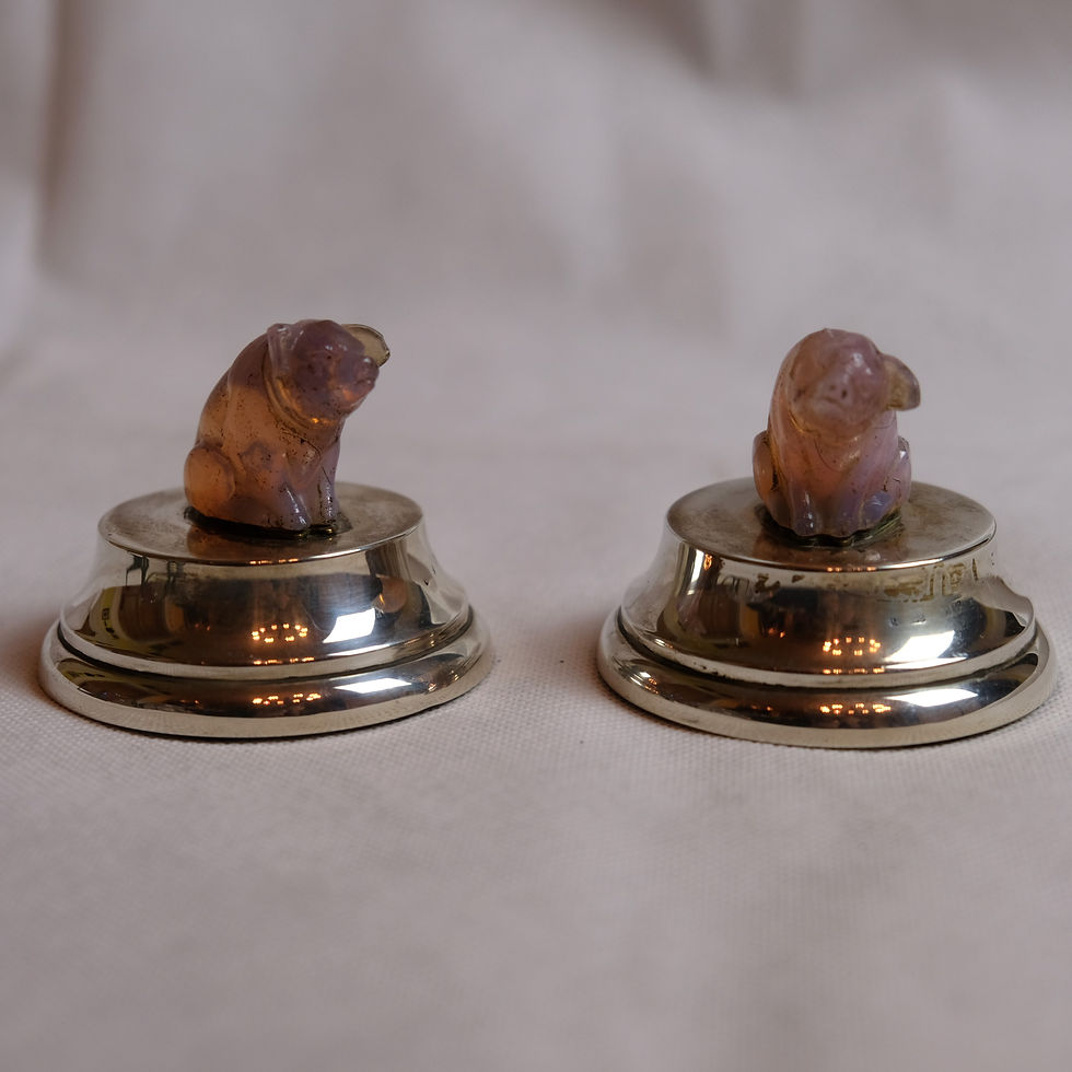 A PAIR OF PINK QUARTZ CRYSTAL PIGS MOUNTED ON SILVER DESK WEIGHTS