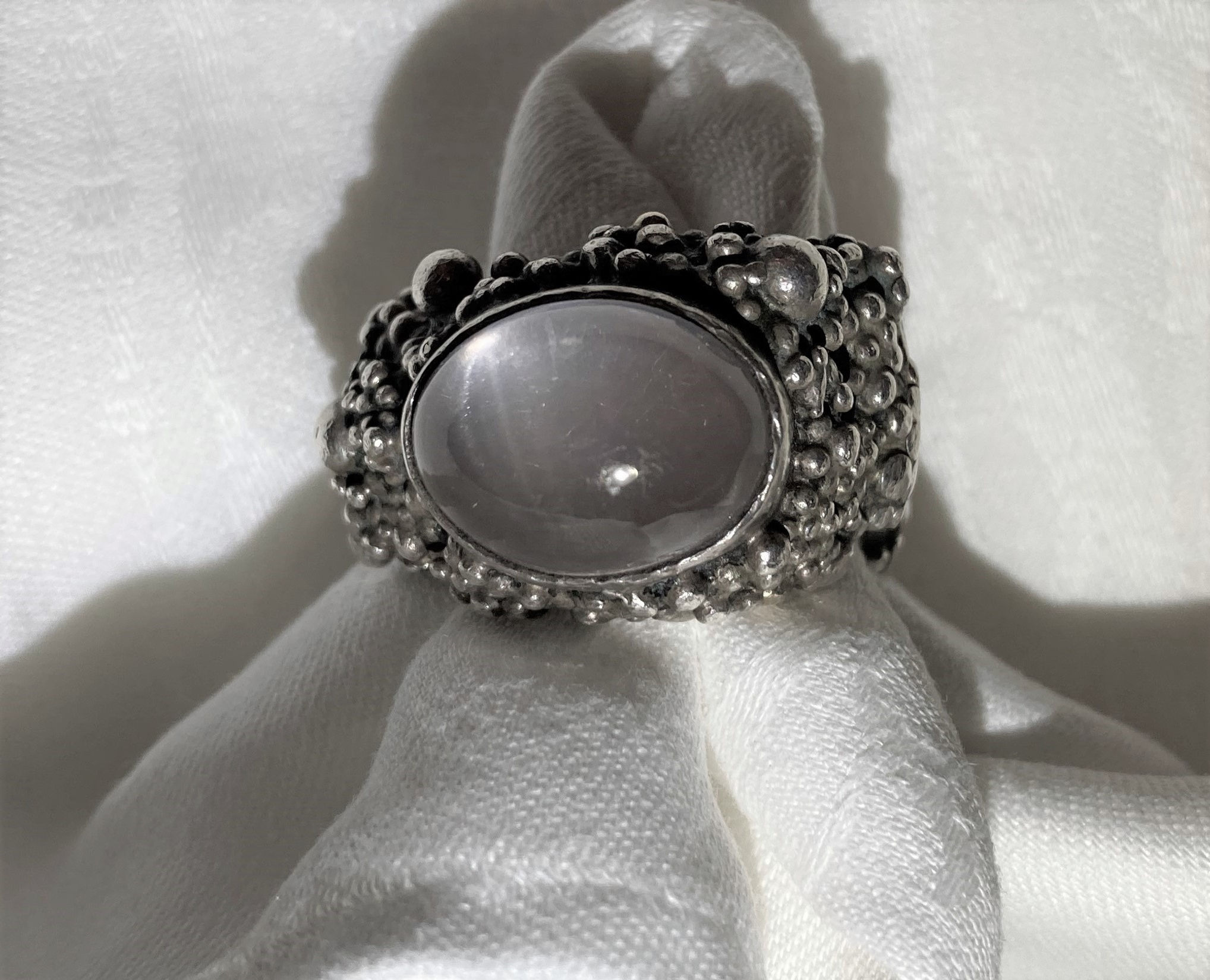Silver ring by Michael A Bolton, set with a moonstone, size S/T