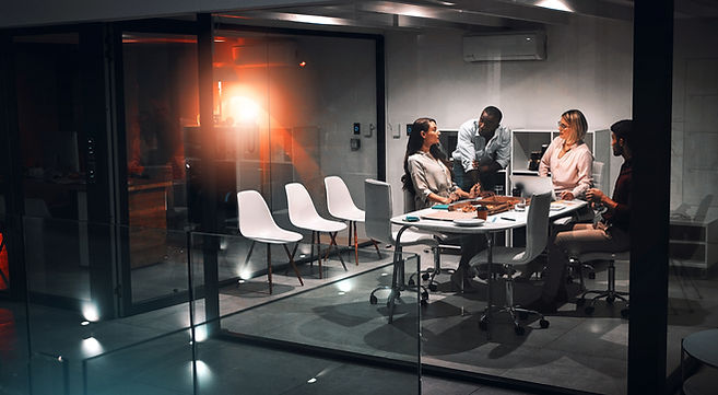 Business people, laptop and planning for design at night in office, creative agency and ov