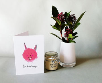 Cute pink bunny head cartoon. Text underneath which reads "Some Bunny Loves You."