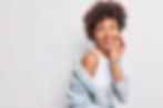 studio-shot-happy-woman-keeps-hand-face-looks-back-with-glad-carefree-expression-notices-s