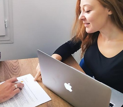 Personalized French lesson with tutor explaining written notes to student in Paris apartment