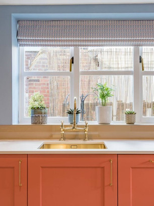quartz worktop, gold metalic sink and taps, stylish orange kitchen units