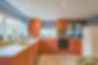 A stylish orange kitchen fitted in staplecross during one of our custom home renovations