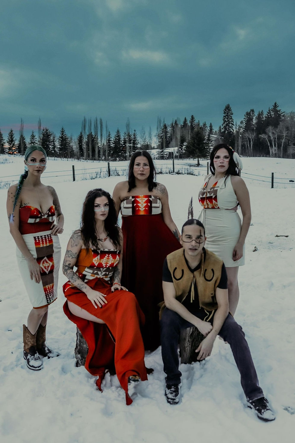 Women in traditional regalia gathered outdoors in winter
