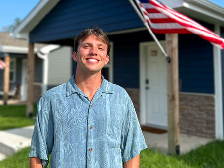 Matzen stands in front of tiny homes at VCP