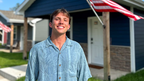 Matzen stands in front of tiny homes at VCP