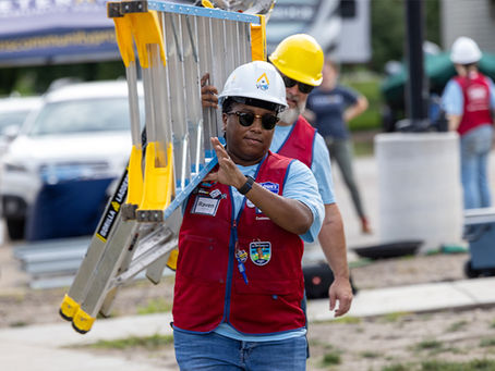 Lowe's employee wearing their signature red vest volunteers at VCP