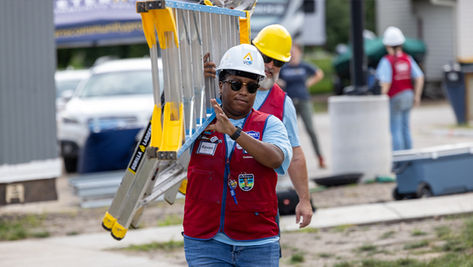 Lowe's employee wearing their signature red vest volunteers at VCP