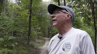 Walker with dog on Fish Creek Park path 