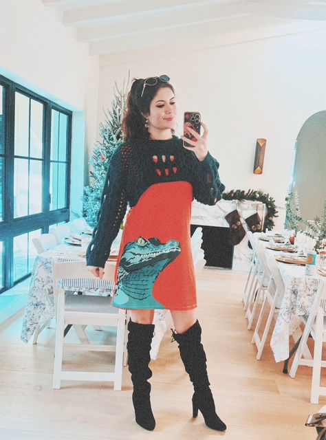 a stylish fashionable young woman in a bold orange tshirt dress with a green gator on it 