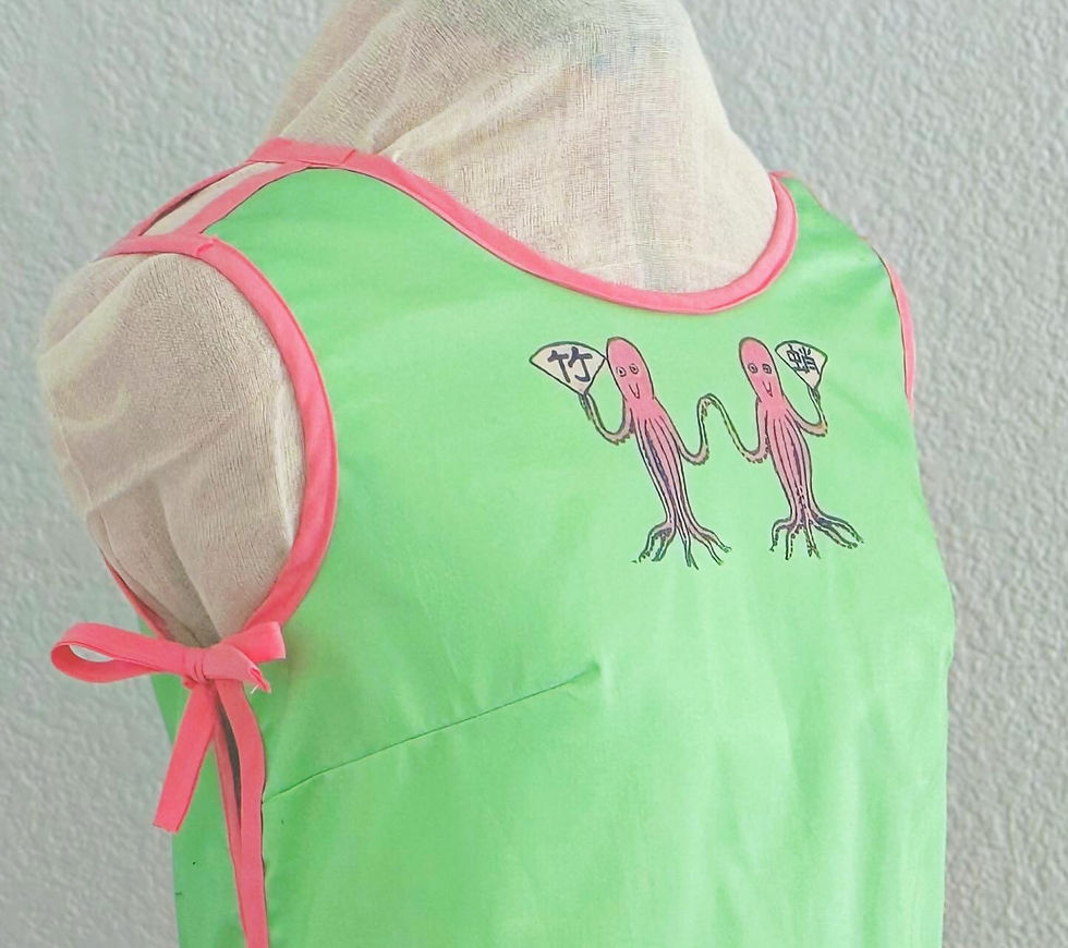 a green crop top with pink piping and pink octopuses from a vintage japaneese matchbook cover