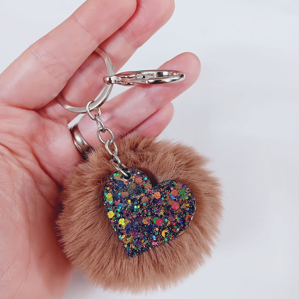Thumbnail: Purple Glitter Resin Heart on Tan Pom Pom Keychain